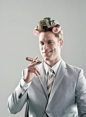 Confident, well-dressed man with hair curlers in and a cigar — a men's salon with a sense of humor
